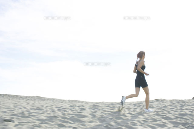 砂浜をランニングをする日本人女性 の写真素材 イラスト素材 アマナイメージズ