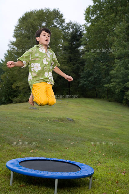 Boy Jumping On Trampoline Outdoors の写真素材 イラスト素材 アマナイメージズ