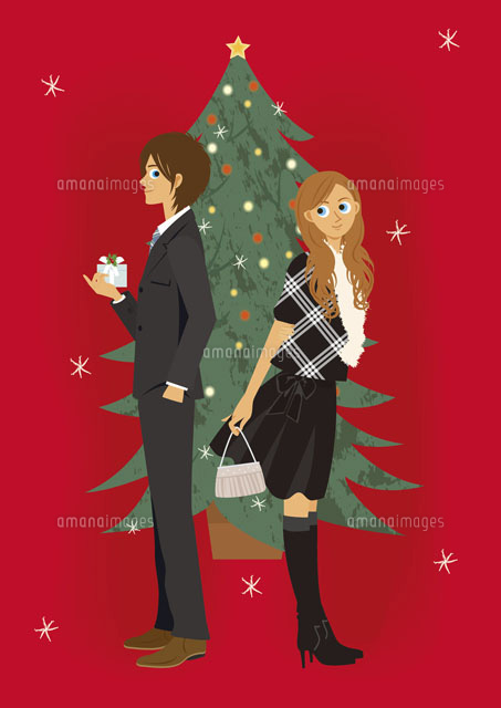 クリスマスツリーの前の若いカップル の写真素材 イラスト素材 アマナイメージズ