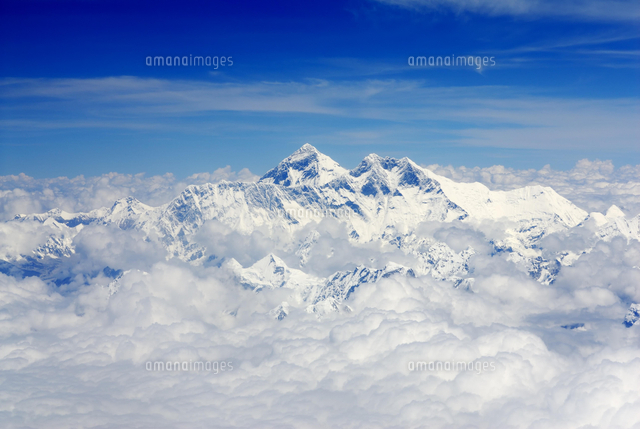 Snow-capped peaks of Mount Everest surrounded by clouds