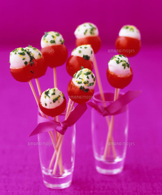 Cocktail tomatoes stuffed with mozzarella on cocktail sticks