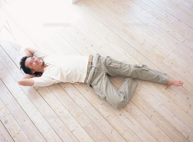 フローリングに寝転ぶ日本人男性 の写真素材 イラスト素材 アマナイメージズ