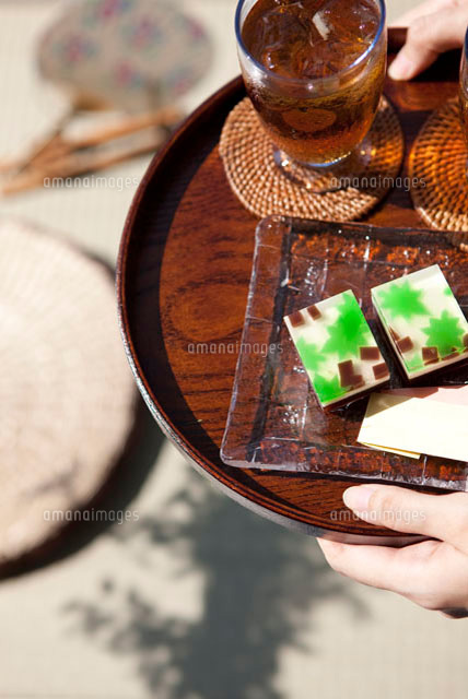 お盆に置かれた麦茶と和菓子を運ぶ女性の手 の写真素材 イラスト素材 アマナイメージズ