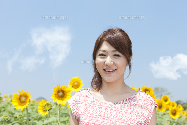 笑顔の女性とひまわり畑 の写真素材 イラスト素材 アマナイメージズ