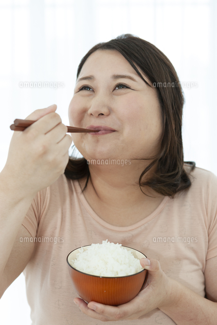 ご飯を食べる太った女性 の写真素材 イラスト素材 アマナイメージズ