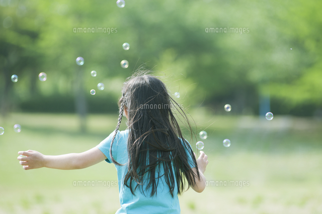 シャボン玉を追いかける女の子の後ろ姿 の写真素材 イラスト素材 アマナイメージズ