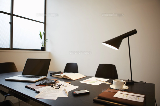 窓際のデスクに置かれたノートパソコンと書類に地球儀 の写真素材 イラスト素材 アマナイメージズ