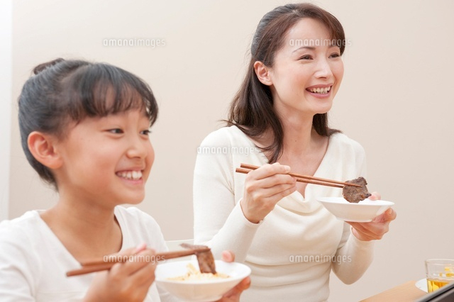 焼肉を食べる母と女の子 の写真素材 イラスト素材 アマナイメージズ