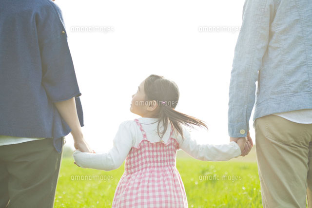 草原で手をつなぐ家族の後ろ姿 の写真素材 イラスト素材 アマナイメージズ
