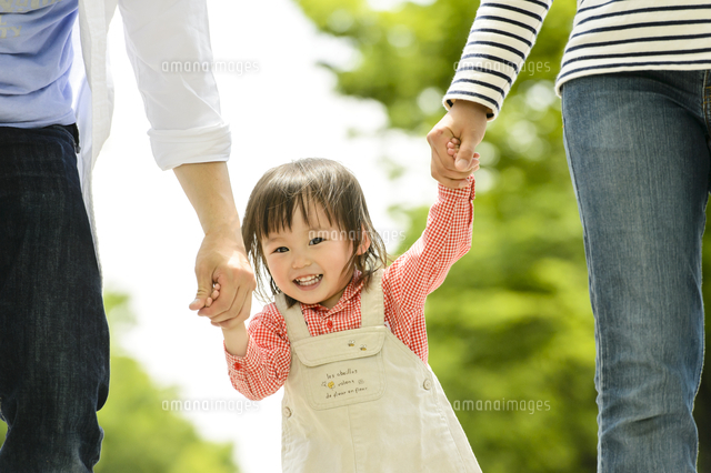 公園で赤ちゃんと手を繋いで歩く家族 の写真素材 イラスト素材 アマナイメージズ