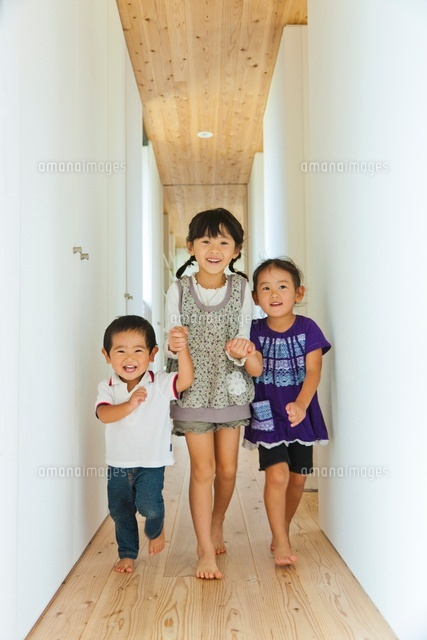 廊下を手を繋いで歩く３人の子供 の写真素材 イラスト素材 アマナイメージズ