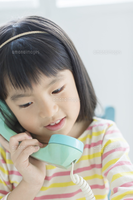 電話をする女の子 の写真素材 イラスト素材 アマナイメージズ