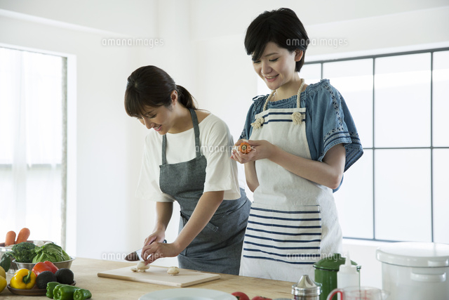 料理を作る笑顔の代女性2人 の写真素材 イラスト素材 アマナイメージズ