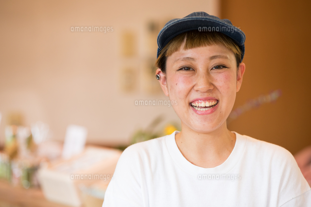 カメラ目線で笑う３０代女性カフェ店員 の写真素材 イラスト素材 アマナイメージズ