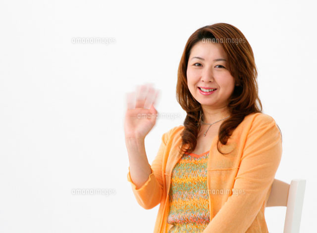 椅子に座って手を振る女性 の写真素材 イラスト素材 アマナイメージズ