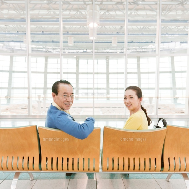 イスに座って振り返るシニア夫婦 の写真素材 イラスト素材 アマナイメージズ