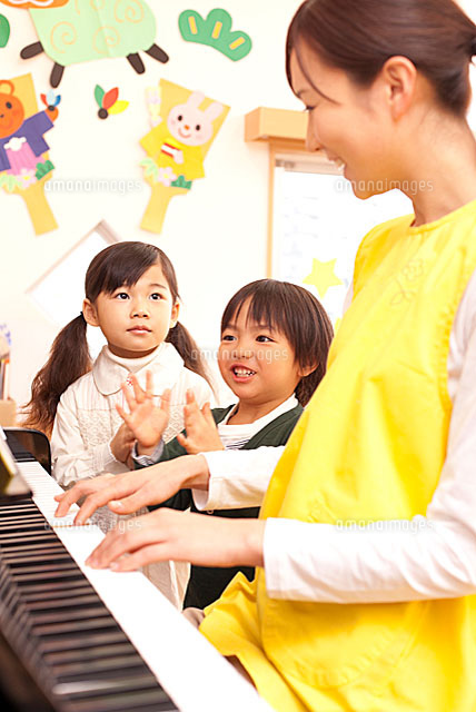 ピアノで遊ぶ子供2人と保育士 の写真素材 イラスト素材 アマナイメージズ