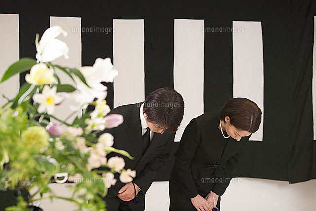 鯨幕の前でお辞儀をする喪服姿の夫婦と花束 の写真素材 イラスト素材 アマナイメージズ