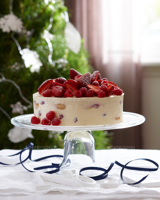 Charlotte russe decorated with strawberries and raspberries on glass ...