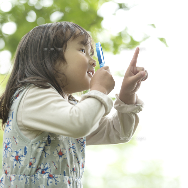 虫眼鏡を持ち観察をする女の子 の写真素材 イラスト素材 アマナイメージズ