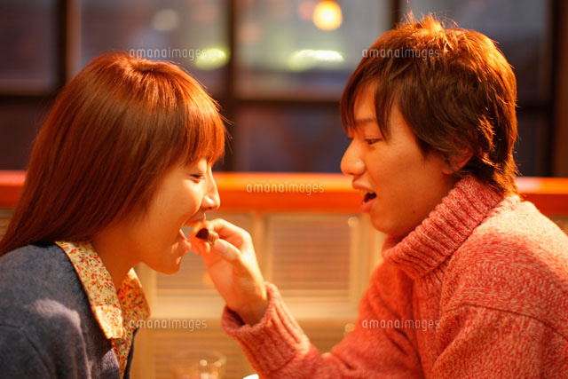 彼女にチョコレートを食べさせる男性 の写真素材 イラスト素材 アマナイメージズ