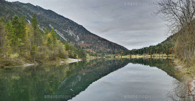 Scenic view of mountains reflected in a clear lake (Plansee) in autumn ...