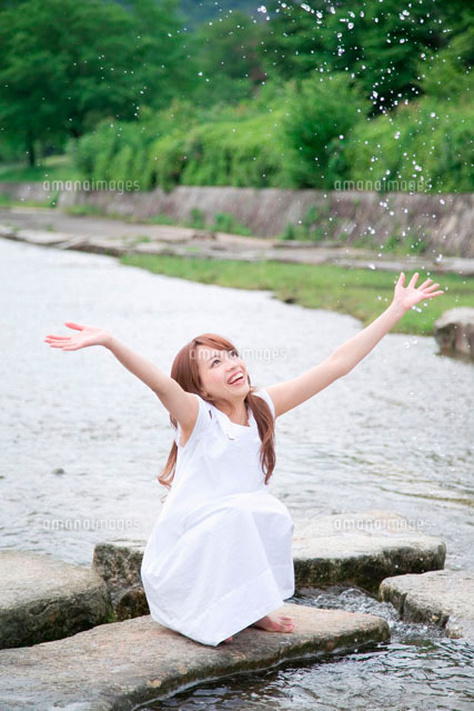 川で水しぶきをあげる女性 の写真素材 イラスト素材 アマナイメージズ