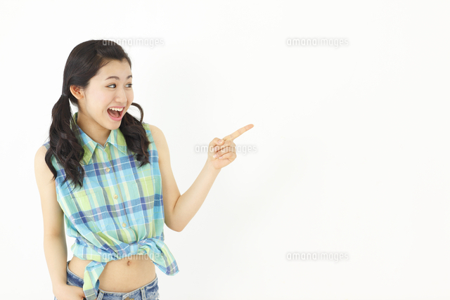 指さしポーズをする女子大学生 の写真素材 イラスト素材 アマナイメージズ