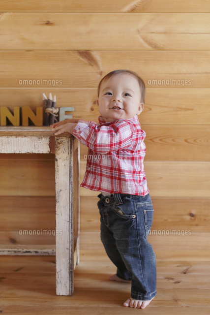 つかまり立ちする赤ちゃん の写真素材 イラスト素材 アマナイメージズ