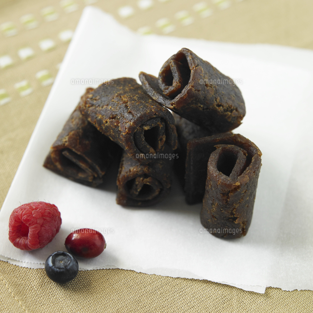 Organic Mixed Berry Fruit Leather on Paper with Fresh Berries