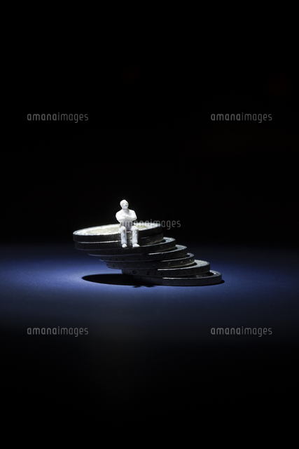 Stack of coins with figurine[11077002982]の写真素材・イラスト素材｜アマナイメージズ