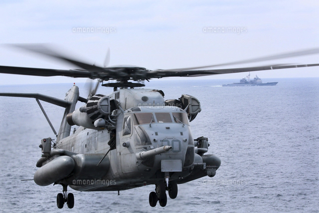 A CH-53 Sea Stallion lifts a HU-25 Guardian Coast Guard airc