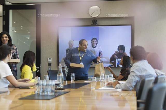 Business people arriving with lunch in conference room meeting ...