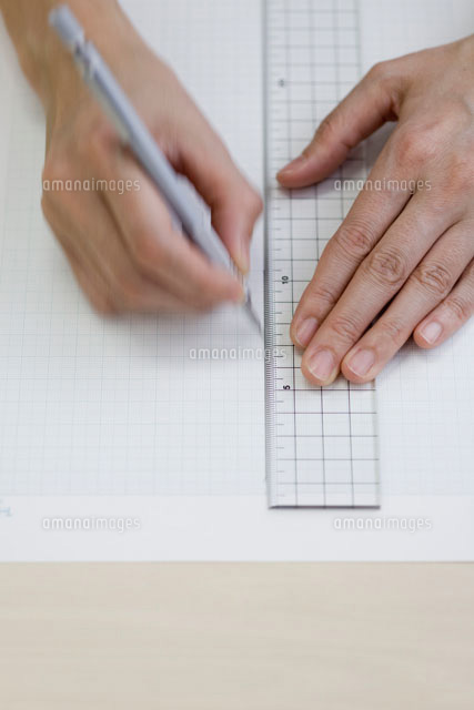 定規で紙に線を引く女性の手元[21106000212]の写真・イラスト素材