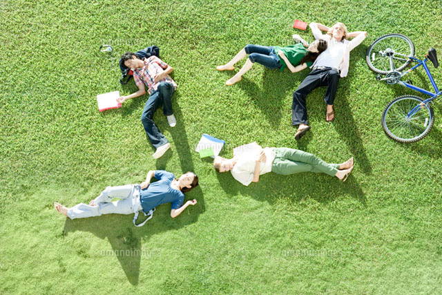 芝生の上に寝転ぶ学生たち の写真素材 イラスト素材 アマナイメージズ
