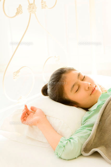 寝室のベットで寝ている日本人の娘 の写真素材 イラスト素材 アマナイメージズ
