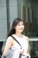 外を歩いているノースリーブ姿の女性 の写真素材 イラスト素材 アマナイメージズ