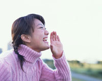 屋外で叫ぶ女性の横顔 の写真素材 イラスト素材 アマナイメージズ